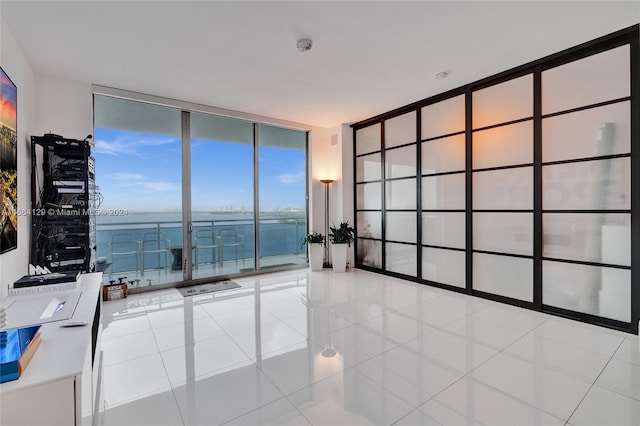 tiled spare room featuring floor to ceiling windows