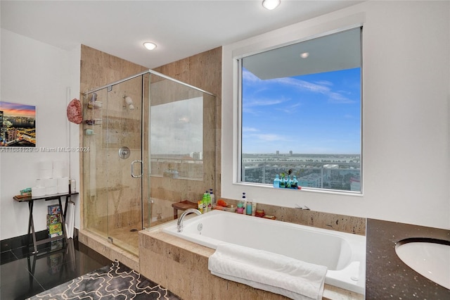 bathroom with independent shower and bath and tile patterned floors