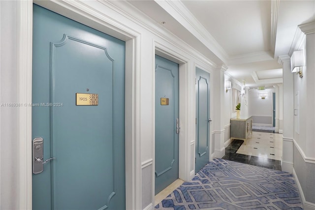 corridor featuring dark tile patterned floors and crown molding