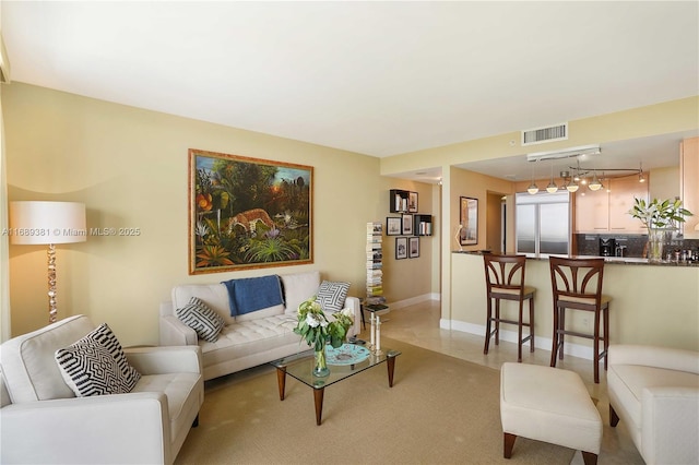 living area featuring visible vents and baseboards