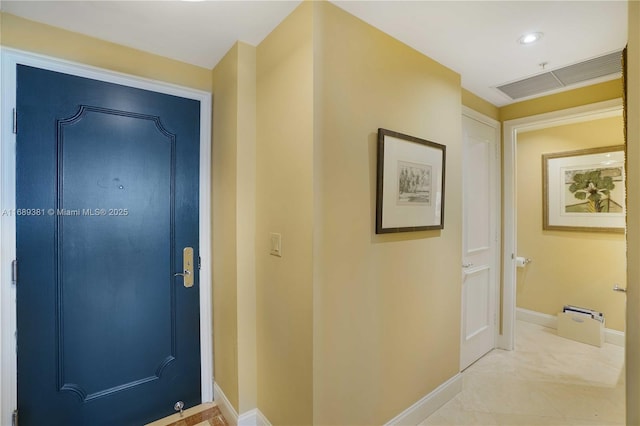 foyer entrance featuring visible vents and baseboards