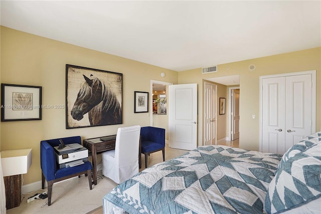 bedroom featuring a closet, visible vents, and baseboards