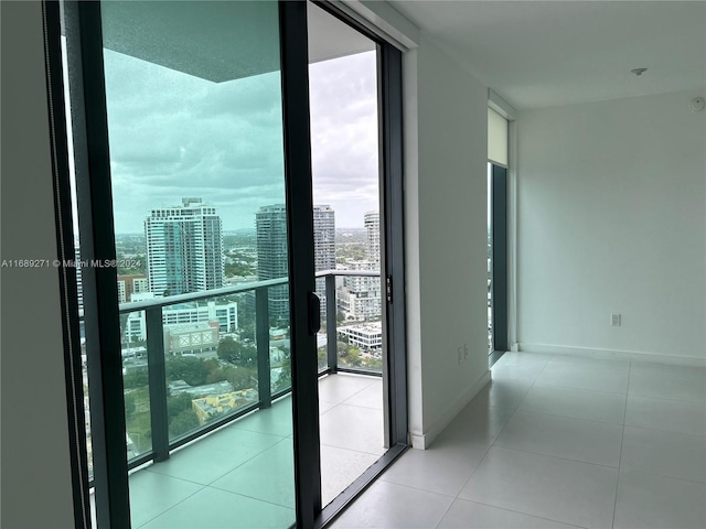 interior space with a wealth of natural light, a wall of windows, and light tile patterned flooring