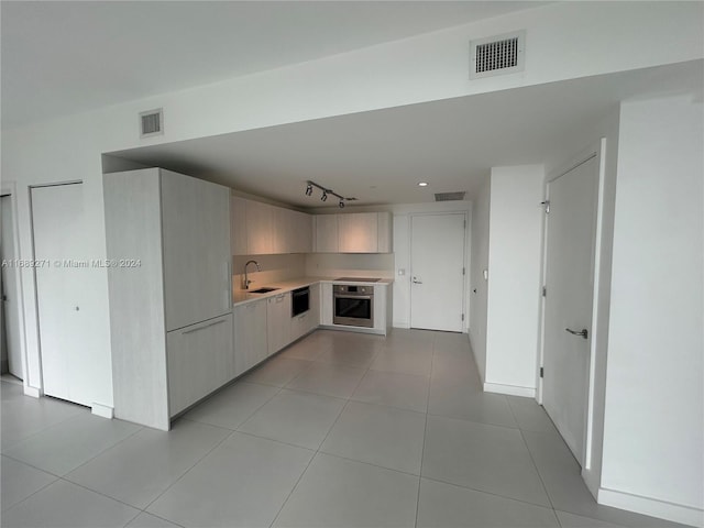 hall with sink and light tile patterned floors