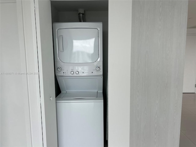 clothes washing area with stacked washer and dryer