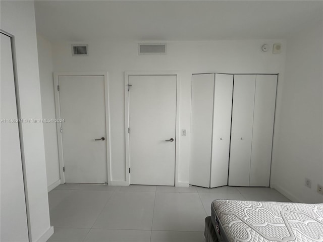 unfurnished bedroom with light tile patterned floors