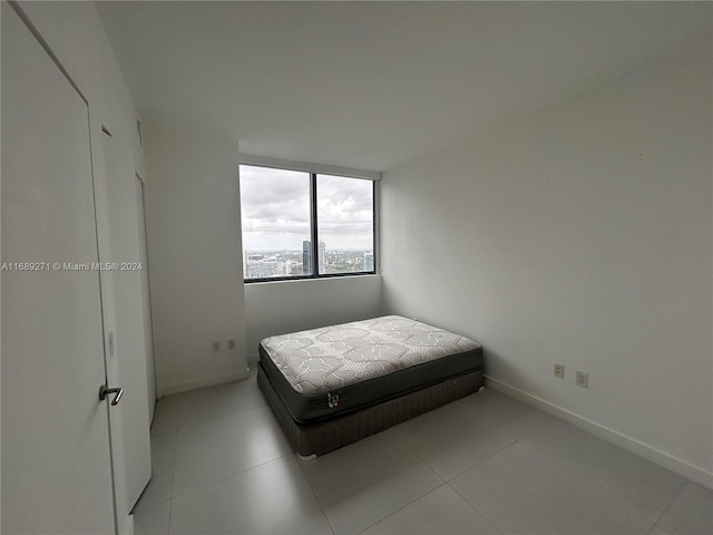 bedroom featuring light tile patterned floors