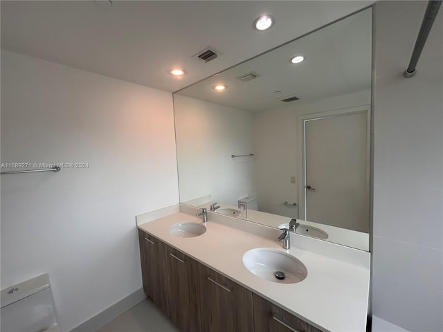 bathroom with toilet and vanity