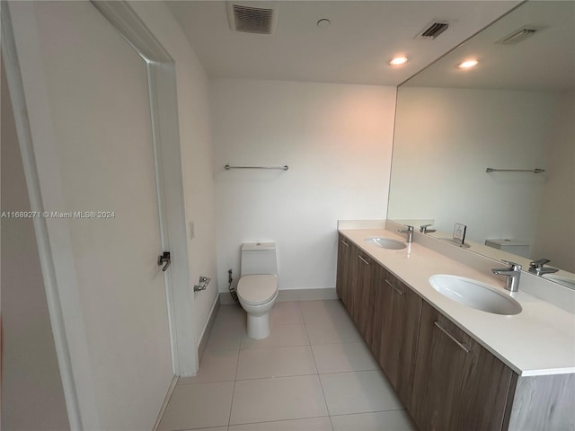 bathroom featuring tile patterned flooring, vanity, and toilet