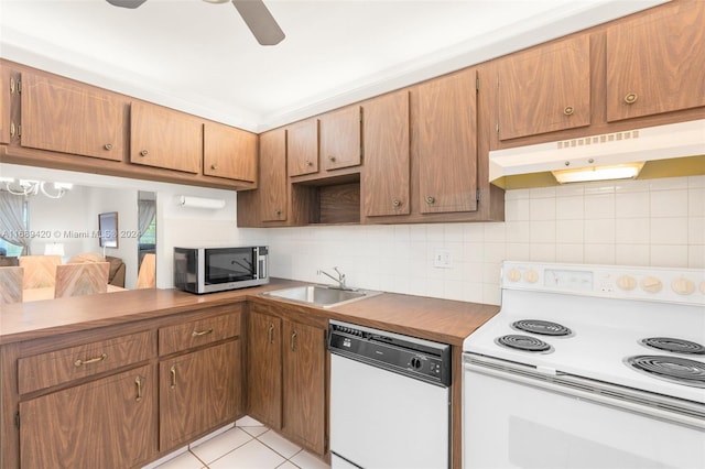 kitchen featuring sink, ceiling fan, light tile patterned floors, backsplash, and white appliances