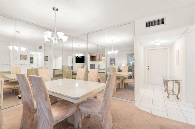 dining area featuring light colored carpet and a textured ceiling