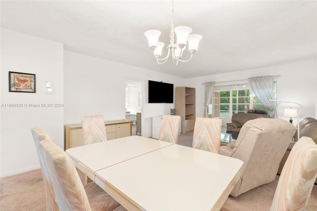 carpeted dining space with an inviting chandelier