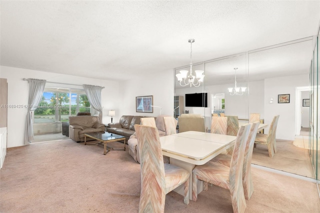 dining room with a chandelier, a textured ceiling, and light carpet