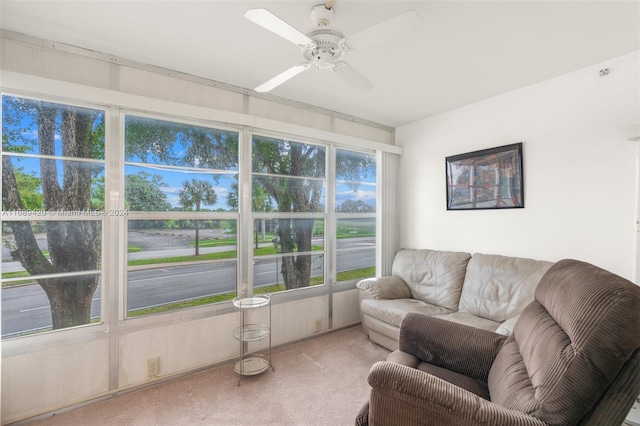 living room featuring carpet and ceiling fan