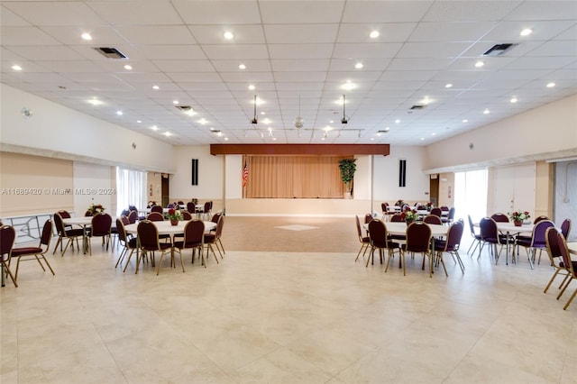 dining space with a drop ceiling