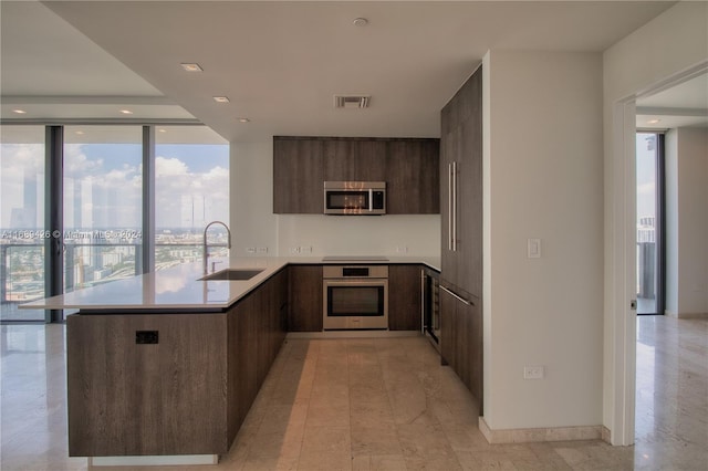 kitchen with stainless steel appliances, sink, and kitchen peninsula