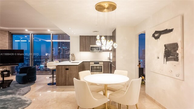 bedroom featuring multiple windows, floor to ceiling windows, and access to exterior