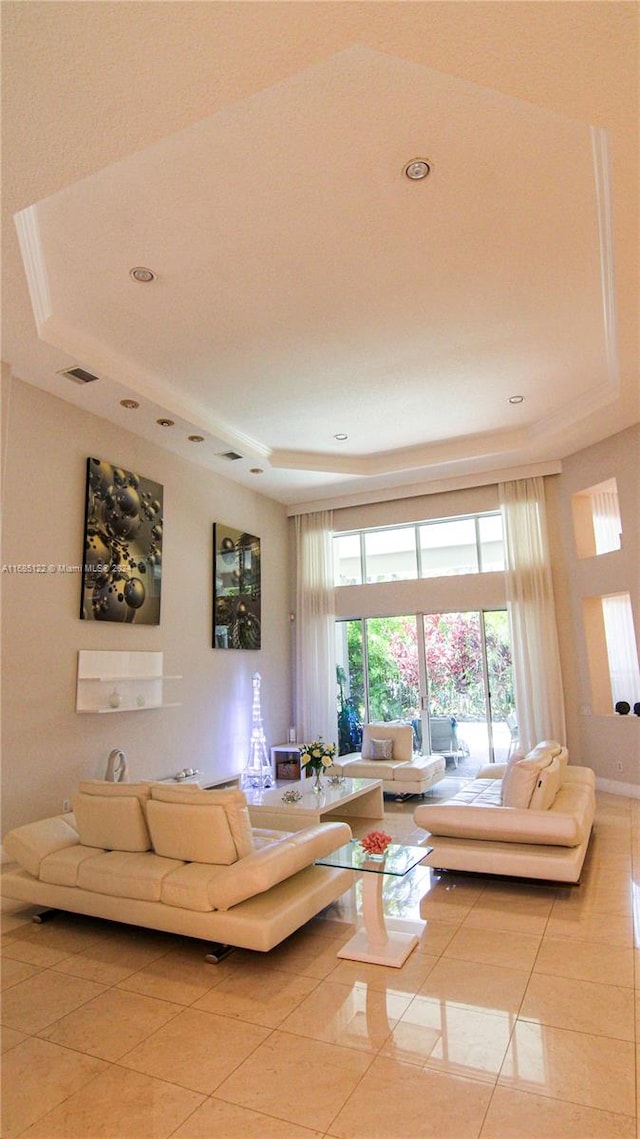 tiled living room with a tray ceiling