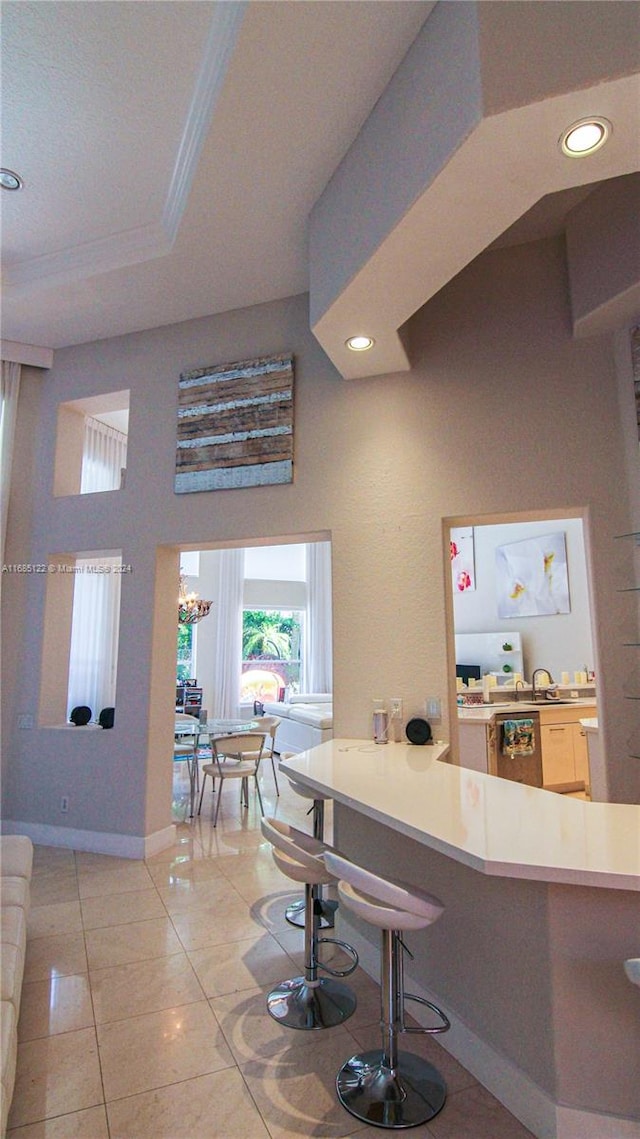 kitchen featuring a breakfast bar area and light tile patterned floors