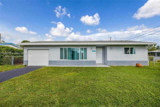 ranch-style home with a garage and a front yard