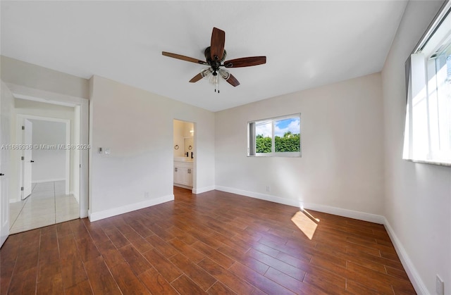 unfurnished room featuring dark hardwood / wood-style floors and ceiling fan