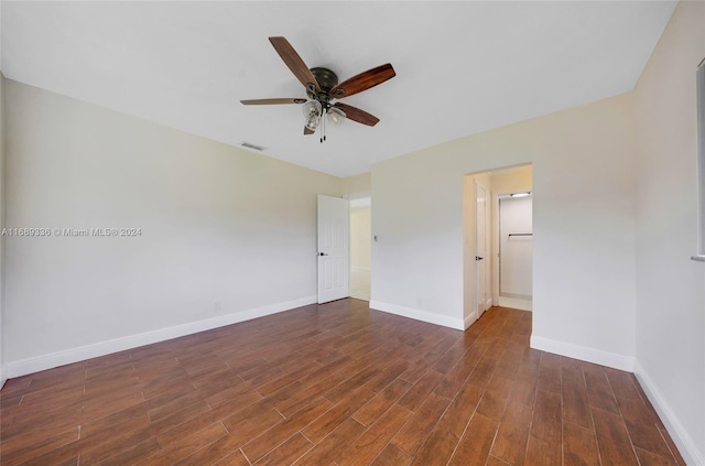 unfurnished bedroom featuring ceiling fan and dark wood-type flooring