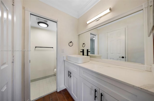 bathroom featuring wood-type flooring, vanity, toilet, and ornamental molding