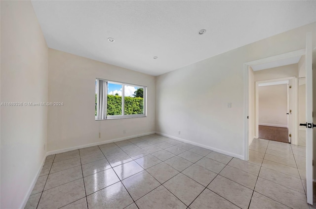 empty room with light tile patterned floors