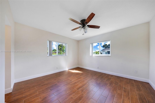 unfurnished room featuring dark hardwood / wood-style floors and ceiling fan