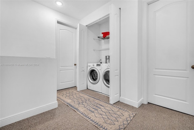 laundry area featuring washing machine and clothes dryer and light colored carpet