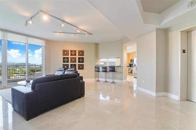 9751 E Bay Harbor Dr Unit 8D, Boat Slip, Bay Harbor Islands, FL 33154 - living area featuring baseboards, elevator, and track lighting