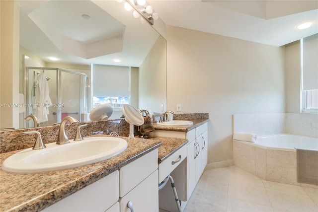 bathroom featuring vanity, independent shower and bath, and tile patterned flooring