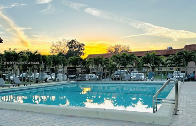 view of pool at dusk