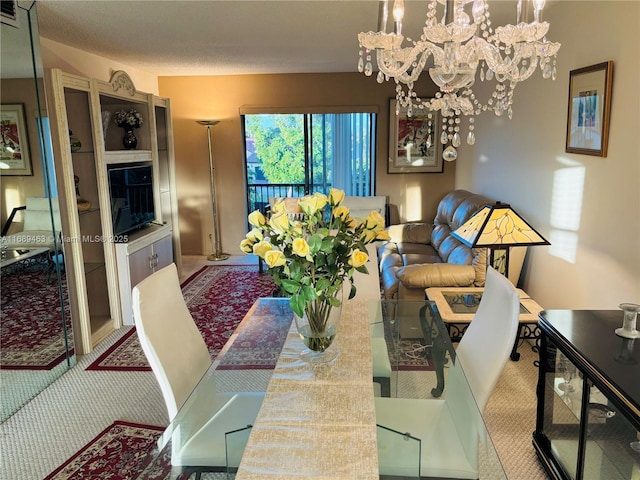 dining room featuring an inviting chandelier and carpet flooring