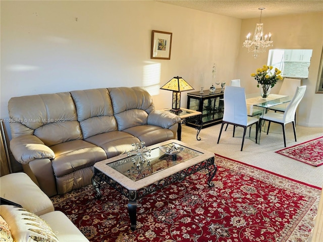 living room featuring carpet flooring, a textured ceiling, and a notable chandelier