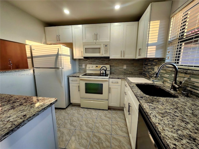 kitchen with white cabinetry, sink, and white appliances