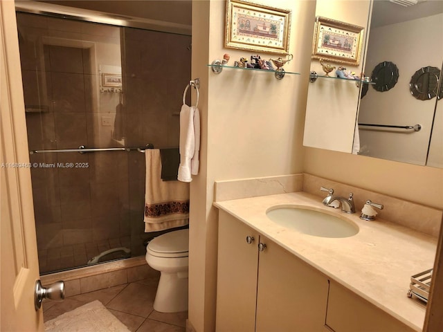 bathroom with tile patterned flooring, vanity, toilet, and walk in shower