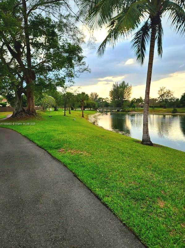 exterior space featuring a water view and a yard