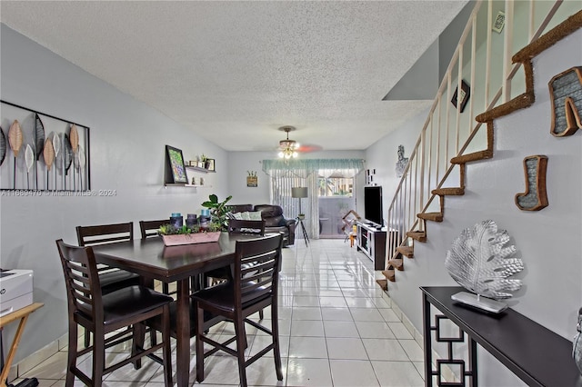 dining room with a textured ceiling, ceiling fan, and light tile patterned flooring