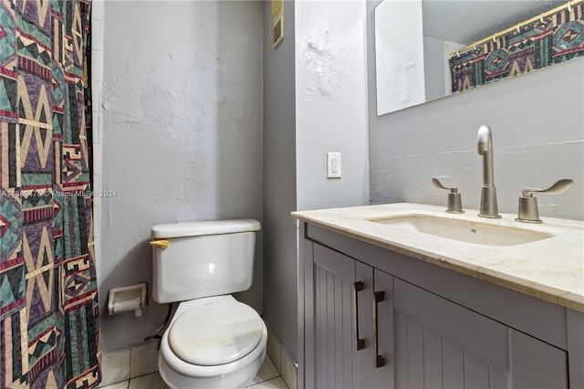 bathroom featuring toilet, vanity, a shower with shower curtain, and tile patterned flooring