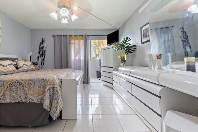 tiled bedroom featuring ceiling fan