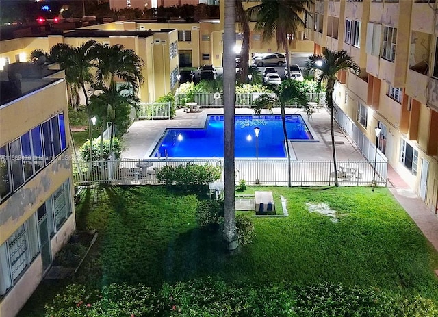 view of swimming pool featuring a patio and a yard