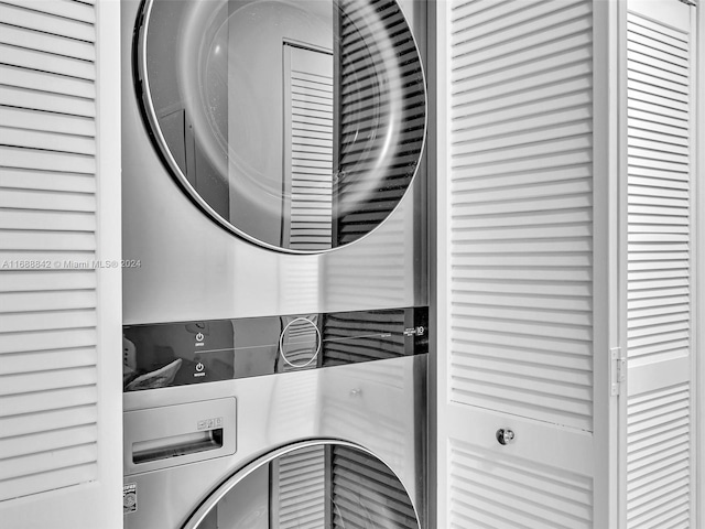 laundry room with stacked washing maching and dryer