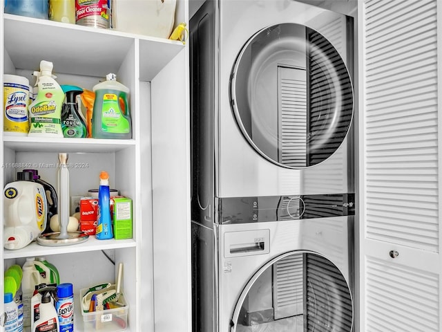 clothes washing area featuring stacked washer and clothes dryer