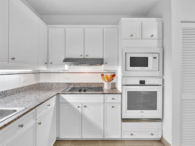 kitchen featuring white cabinetry, white appliances, backsplash, and light tile patterned floors