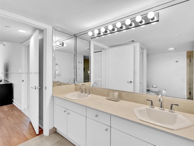 bathroom with hardwood / wood-style floors, vanity, and a bidet