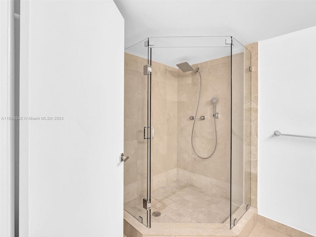 bathroom featuring tile patterned floors and a shower with door