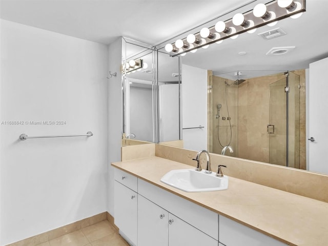 bathroom with vanity, tile patterned floors, and an enclosed shower