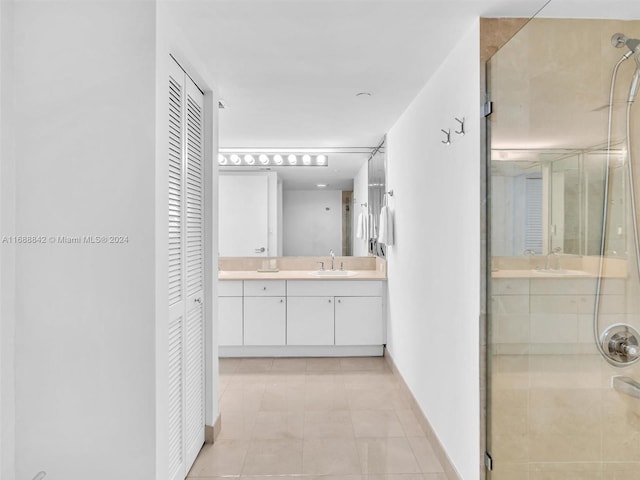 bathroom with tile patterned flooring, vanity, and an enclosed shower