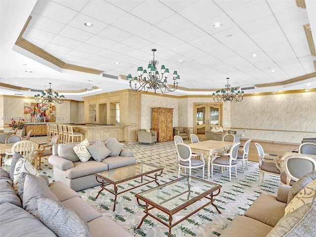 carpeted living room featuring a raised ceiling, an inviting chandelier, and ornamental molding